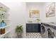 Stylish laundry room features a modern washer and dryer set and decorative tile floors at 6514 W Apex Ave, Queen Creek, AZ 85144