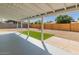 Large gravel backyard with small patch of artificial turf and mature trees at 6610 N 15Th Ave, Phoenix, AZ 85015