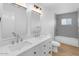Bathroom showcasing dual sinks, modern fixtures, and a tiled shower-tub combination at 6610 N 15Th Ave, Phoenix, AZ 85015