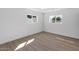 Bedroom featuring plank floors and two windows for ample natural light at 6610 N 15Th Ave, Phoenix, AZ 85015