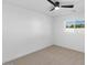 Cozy bedroom with neutral carpet, ceiling fan, and a window offering natural light at 6610 N 15Th Ave, Phoenix, AZ 85015