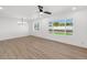 Inviting empty room with sleek flooring, modern ceiling fan, and expansive windows at 6610 N 15Th Ave, Phoenix, AZ 85015