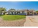 Well-kept single-story home featuring a green lawn and covered parking area at 6610 N 15Th Ave, Phoenix, AZ 85015
