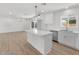 Updated kitchen with an island and stainless steel appliances flows into a spacious living area, ideal for entertaining at 6610 N 15Th Ave, Phoenix, AZ 85015