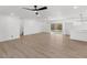 Open-concept living room with white walls, wood floors, and modern fixtures flows seamlessly into the kitchen area at 6610 N 15Th Ave, Phoenix, AZ 85015
