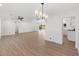 Spacious living room features light wood floors, white walls, and modern light fixtures, creating a clean and inviting space at 6610 N 15Th Ave, Phoenix, AZ 85015