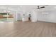 Bright and airy living room with light wood floors and white walls, showcasing modern lighting fixtures at 6610 N 15Th Ave, Phoenix, AZ 85015