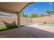 Relaxing covered patio with views of a refreshing pool and low maintenance yard at 8010 W Adam Ave, Peoria, AZ 85382