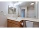 Bright bathroom showcasing a wooden vanity, a large mirror, and good lighting at 8010 W Adam Ave, Peoria, AZ 85382
