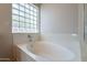 Bright bathroom featuring a large bathtub and a window block at 8010 W Adam Ave, Peoria, AZ 85382