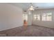 Bright airy bedroom featuring carpeted flooring, dual windows, and an adjoining room with a desk at 8010 W Adam Ave, Peoria, AZ 85382