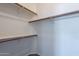 Spacious walk-in closet featuring wood shelving and carpeted flooring for ample storage at 8010 W Adam Ave, Peoria, AZ 85382