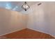 Neutral dining room with hardwood floors and decorative light fixture at 8010 W Adam Ave, Peoria, AZ 85382