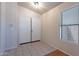 Bright entryway featuring tile floors, a window with blinds, and a double door entry at 8010 W Adam Ave, Peoria, AZ 85382