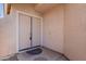 Close-up of a double door entrance featuring a welcome mat and neutral color scheme at 8010 W Adam Ave, Peoria, AZ 85382