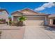 Charming home with two car garage, desert landscaping, and well maintained lawn at 8010 W Adam Ave, Peoria, AZ 85382