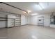 Large garage with storage shelves and cabinetry at 8010 W Adam Ave, Peoria, AZ 85382
