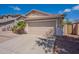 Attached two-car garage with a paved driveway and well-maintained exterior at 8010 W Adam Ave, Peoria, AZ 85382