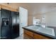 Kitchen with black refrigerator and a large white sink at 8010 W Adam Ave, Peoria, AZ 85382