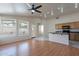 Open-concept living space with wood floors adjoining the kitchen area at 8010 W Adam Ave, Peoria, AZ 85382