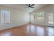 Bright living room features wood floors, large windows and ceiling fan at 8010 W Adam Ave, Peoria, AZ 85382