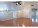 Open living area with wood floors, ceiling fans, modern lighting, and partial walls at 8010 W Adam Ave, Peoria, AZ 85382