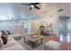 Bright living room with contemporary furniture, ceiling fan, and adjacent dining area at 8010 W Adam Ave, Peoria, AZ 85382