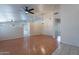 Open-concept living area with wood flooring, ceiling fans, and abundant natural light at 8010 W Adam Ave, Peoria, AZ 85382