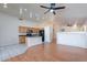 Open-concept living area with kitchen, wood floors and vaulted ceiling at 8010 W Adam Ave, Peoria, AZ 85382