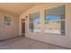 Cozy covered patio with large windows that overlook the backyard oasis at 8010 W Adam Ave, Peoria, AZ 85382