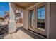 Inviting covered patio featuring dual glass doors to bring in natural light at 8010 W Adam Ave, Peoria, AZ 85382