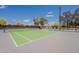 Well-maintained community tennis court with green playing surface, net, and surrounding fence at 8010 W Adam Ave, Peoria, AZ 85382