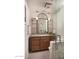 Elegant bathroom features a granite countertop vanity and glass enclosed shower with decorative framed mirror at 8220 E Crestwood Way, Scottsdale, AZ 85250