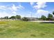 Wide backyard featuring green field and covered parking space with clear blue skies and scattered clouds at 944 E Melody Dr, Gilbert, AZ 85234