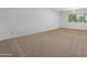 Spacious bedroom with carpet and a bright window at 944 E Melody Dr, Gilbert, AZ 85234