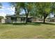 Ranch style house with mature trees and manicured lawn at 944 E Melody Dr, Gilbert, AZ 85234