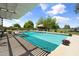 Beautiful pool area featuring a pergola and lush landscaping for a serene backyard oasis at 944 E Melody Dr, Gilbert, AZ 85234
