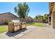 Backyard with built-in barbecue on a concrete patio and well-kept lawn at 1115 E Locust Dr, Chandler, AZ 85286