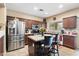 Well-appointed kitchen with stainless steel appliances, granite countertops, and stylish dark-wood cabinetry at 1115 E Locust Dr, Chandler, AZ 85286
