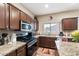 Functional kitchen featuring stainless steel appliances, granite countertops, and a well-lit workspace at 1115 E Locust Dr, Chandler, AZ 85286