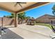 Covered patio with built-in barbecue, ceiling fan, and well-maintained landscaping at 1115 E Locust Dr, Chandler, AZ 85286