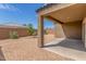 Backyard featuring a patio area and gravel landscape with lush plants, offering a tranquil outdoor oasis at 1239 E Elaine St, Casa Grande, AZ 85122