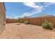 Spacious backyard with desert landscaping and a block wall fence offers privacy and low maintenance at 1239 E Elaine St, Casa Grande, AZ 85122