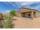 Backyard featuring a patio area and gravel landscape with lush plants, offering a tranquil outdoor oasis at 1239 E Elaine St, Casa Grande, AZ 85122