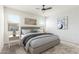 Staged primary bedroom featuring a neutral color palette, carpet flooring, and natural light at 1239 E Elaine St, Casa Grande, AZ 85122