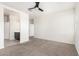 Bedroom with neutral paint, carpet flooring, ceiling fan and access to the ensuite bathroom at 1239 E Elaine St, Casa Grande, AZ 85122