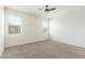 Bedroom with neutral paint, carpet flooring, ceiling fan and two windows at 1239 E Elaine St, Casa Grande, AZ 85122