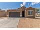 Charming single-story home with a two-car garage and low maintenance desert landscaping at 1239 E Elaine St, Casa Grande, AZ 85122