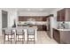 Spacious kitchen featuring dark wood cabinets, stainless appliances and granite countertops at 1239 E Elaine St, Casa Grande, AZ 85122