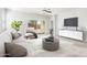 Bright living room featuring neutral decor, ceiling fan, and sliding glass door to the backyard at 1239 E Elaine St, Casa Grande, AZ 85122